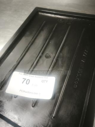 Multi-purpose black plastic tray or lid with ribbed design, marked "PCI Auctions". In good condition with visible tag.