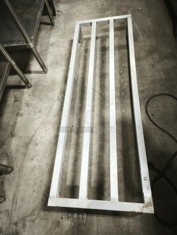 Silver metal frame with parallel bars, likely shelving or a rack. Label indicating "LOT 72, QTY 1." Appears in used condition.