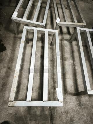 Metallic framework structure with visible rust, placed on a concrete floor. Labels marked '73' and '59' indicate item numbers.