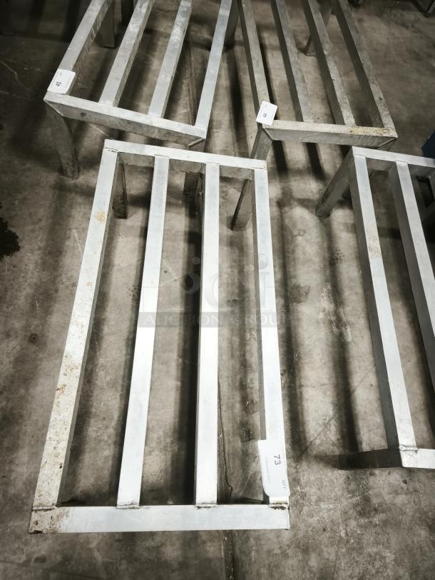 Alt text: Metal frame structures with uniformly spaced parallel bars, featuring visible labels with numbers for identification.