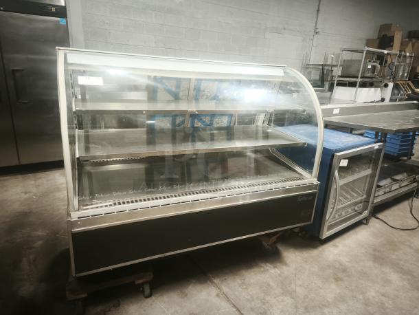 Turbo Air TD-5R curved glass deli display case, 59-inch, used condition, spacious shelves, minor wear, model markings visible.