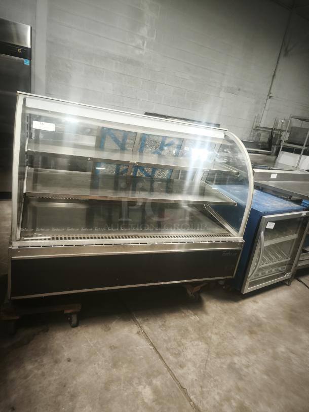 Turbo Air TD-5R curved glass deli display case, 59". Features dual shelves, stainless steel interior. Good condition.