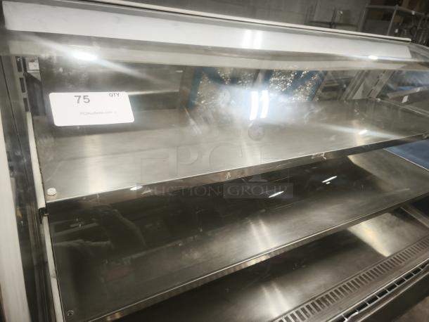 Turbo Air TD-5R curved glass display case, 59", stainless steel shelves, good condition, for deli/bakery goods.