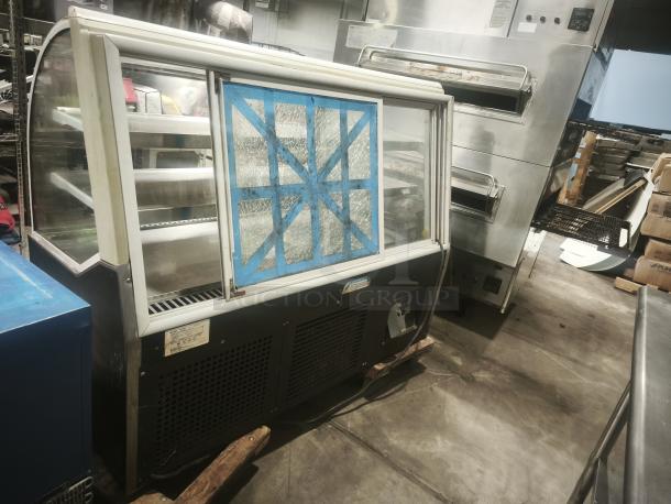 Turbo Air TD-5R curved glass deli display case, 59". Features glass fractures secured with tape. Used condition, label visible.