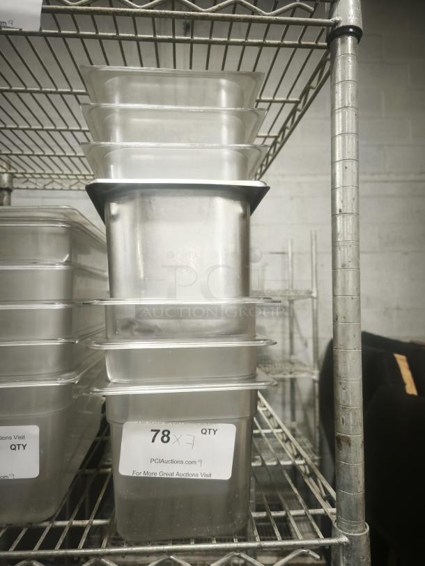 Stack of third size steam pans on metal shelf, in good condition, labeled "78 X 7 QTY" by PCI Auctions.