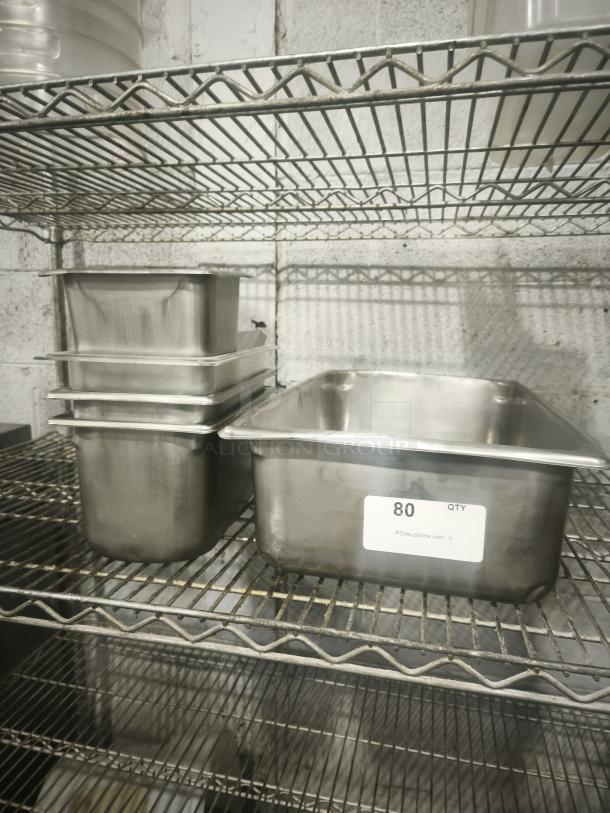 Mixed sizes stainless steel steam pans on metal shelf, label indicates quantity 80, in good condition.