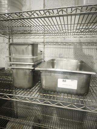 Mixed sizes stainless steel steam pans on metal shelf, label indicates quantity 80, in good condition.
