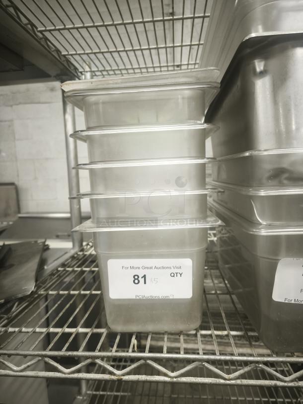 Translucent plastic third-size steam pan with lids on wire shelf. Sticker indicates quantity of five. Ideal for kitchen use.