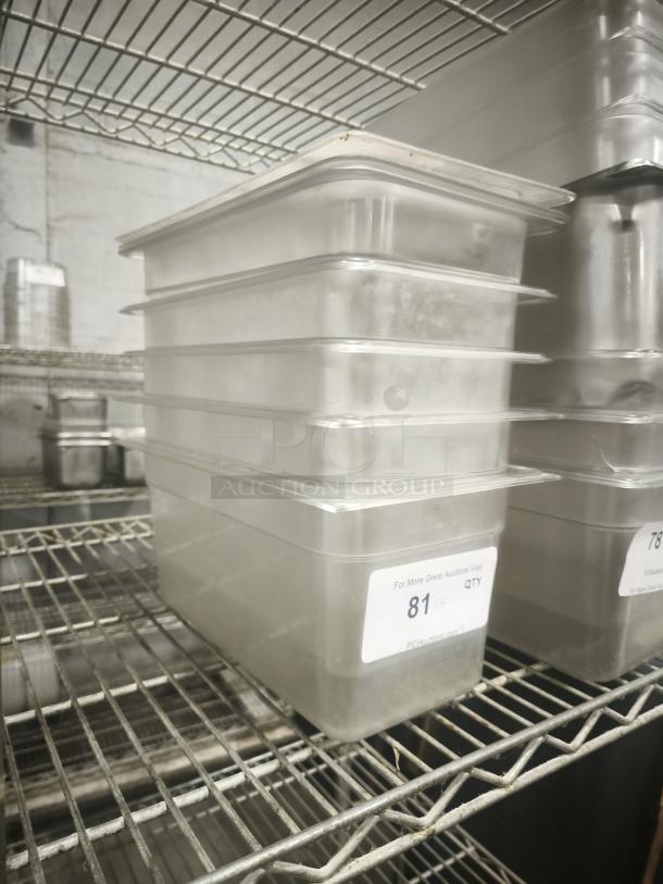 Translucent plastic third size steam pan with lids, stacked on a metal shelf. Label shows auction lot number 81.