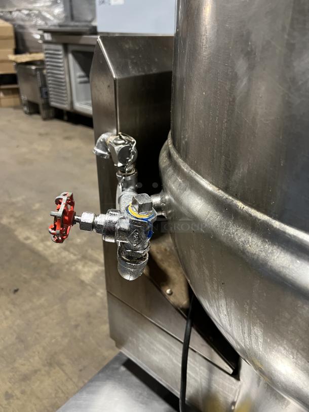 Groen DH140 commercial stainless steel tilt steam kettle, natural gas, 40 gal, on legs. Features valve and serial number 84256.