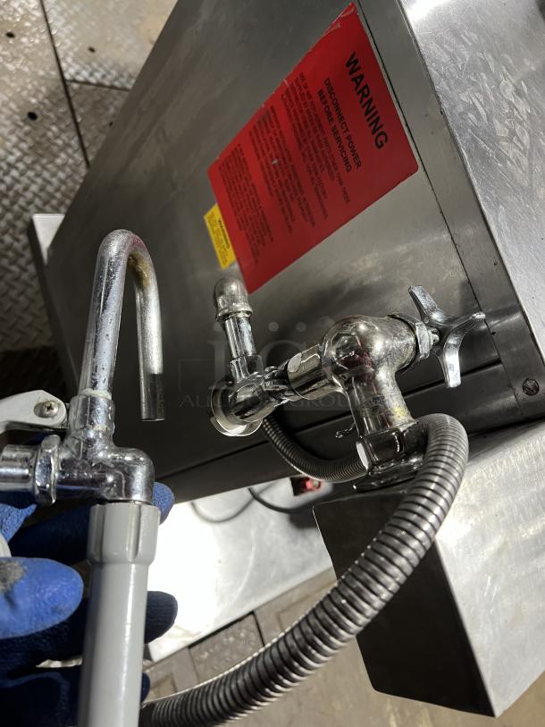 Groen DH140 tilting steam kettle, stainless steel, 40-gal capacity, on legs, natural gas-powered. Warning label visible.