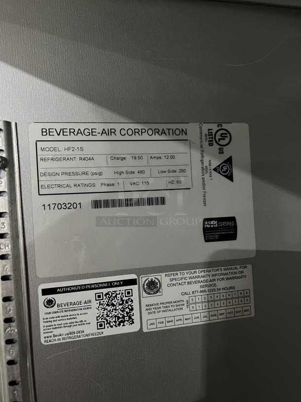 Beverage Air Model HF2-1S label on stainless steel refrigerator, showing specs and SN: 11703201. Poly-coated wired rack included.
