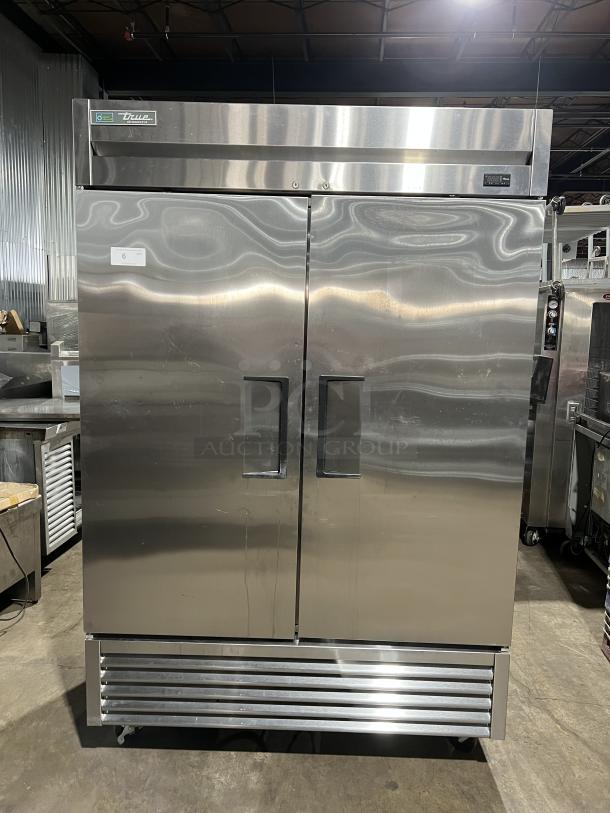 True T49HC commercial stainless steel 2-door reach-in refrigerator on casters, with poly-coated wired rack, in excellent condition.