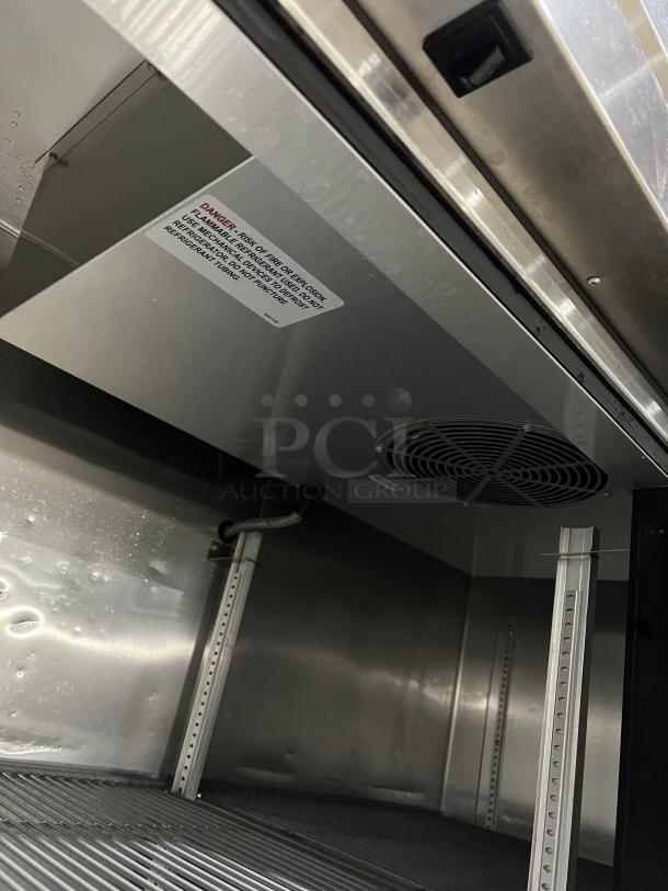 True T49HC commercial refrigerator interior, stainless steel, poly-coated wired rack, fan visible. Model: T-49-HC SN: 9116892.