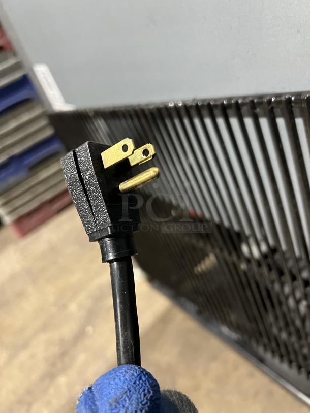 Power plug of True T-49-HC Commercial Refrigerator, 115V, black cord, close-up view.