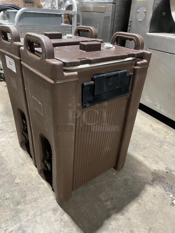 Cambro Carlisle Series brown insulated beverage dispenser, commercial-grade. Features secure lid and sturdy handles.