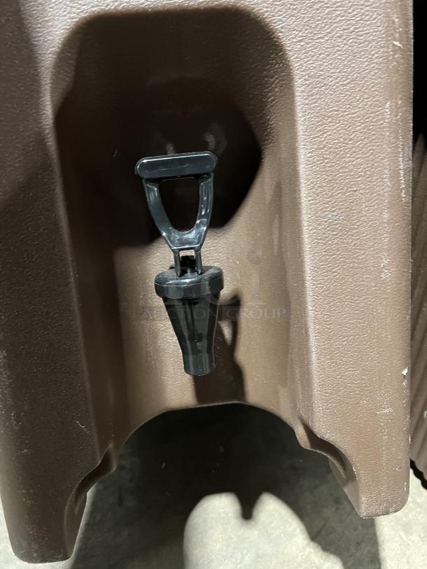 Cambro Carlisle Series brown insulated beverage dispenser spout close-up, in good condition, commercial-grade.