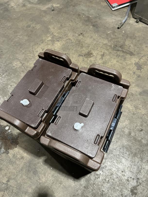 Cambro Carlisle Series brown insulated beverage dispensers, commercial-grade, dual units, sturdy handles, slightly worn condition.