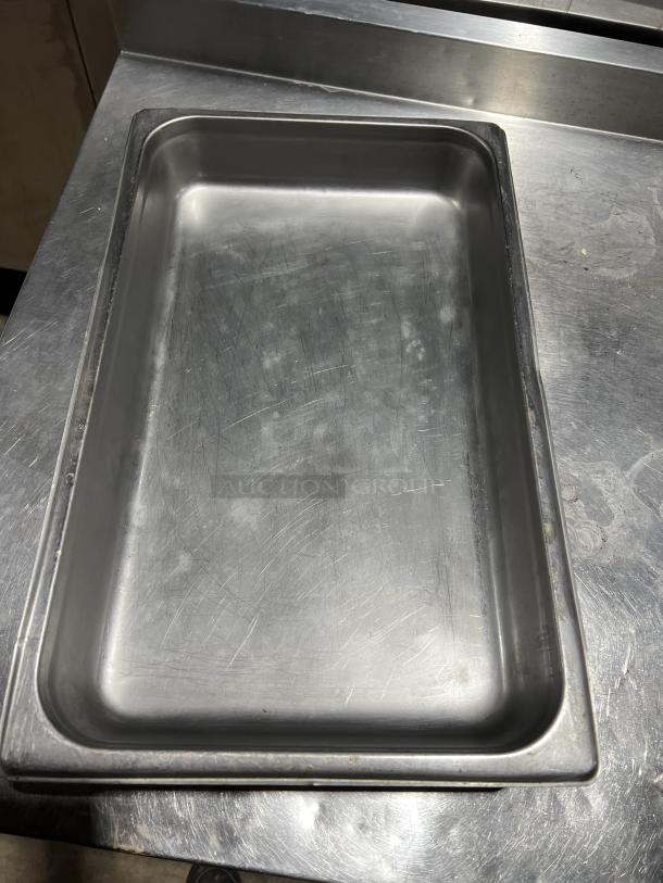 Commercial stainless steel steam table pan, stackable design, lightly scratched surface, durable kitchen equipment.