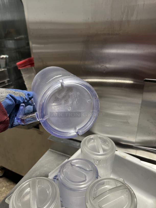 Clear polycarbonate beverage pitcher, commercial-grade, with handle. Features stackable design. Ideal for restaurants.