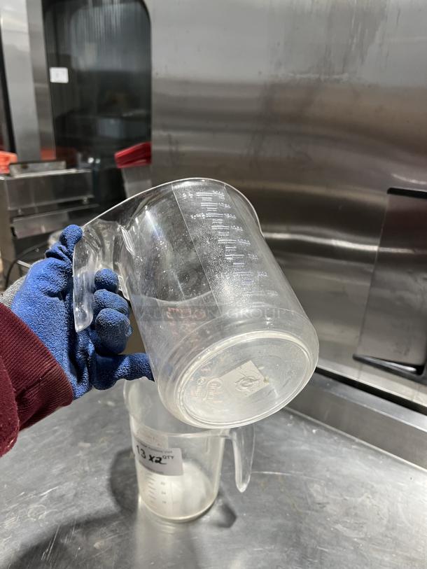 Choice Commercial 2 Qt. Clear Polycarbonate Measuring Cup, sturdy handle, embossed measurements, minor wear, branded base.