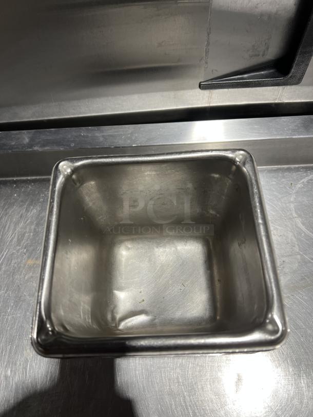 Stainless steel steam table pan, commercial grade, showing interior. Slight wear visible. Ideal for catering use.
