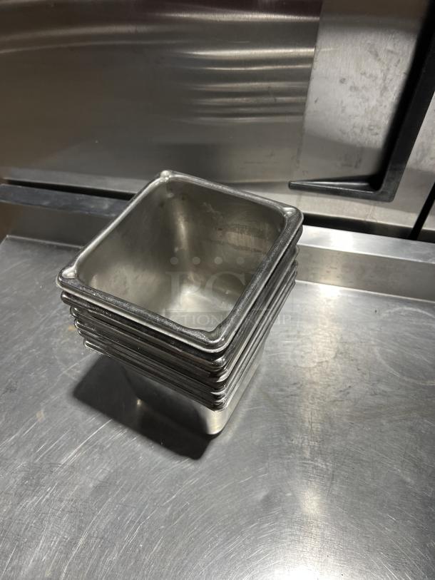 Stack of commercial stainless steel steam table pans, used, shiny finish, size 6X, in good condition.
