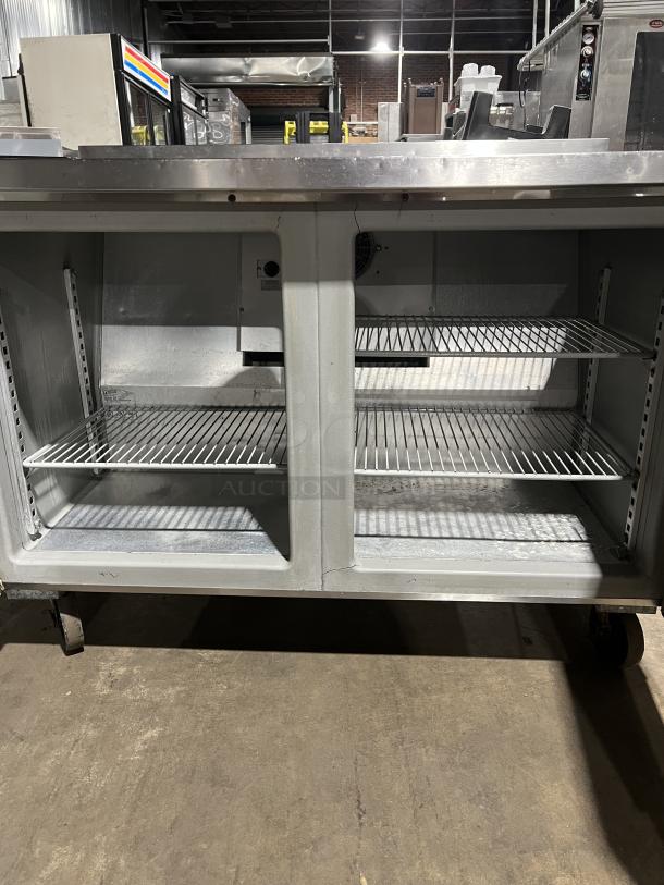Randell Commercial Stainless Steel 2 Door Flat-Top Worktop Refrigerator, Model 9302-7, on casters, includes shelving.
