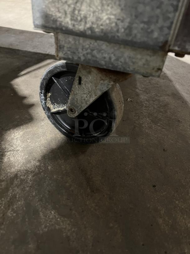 Close-up of a caster wheel on the Randell Model 93027 commercial stainless steel 2-door worktop refrigerator.
