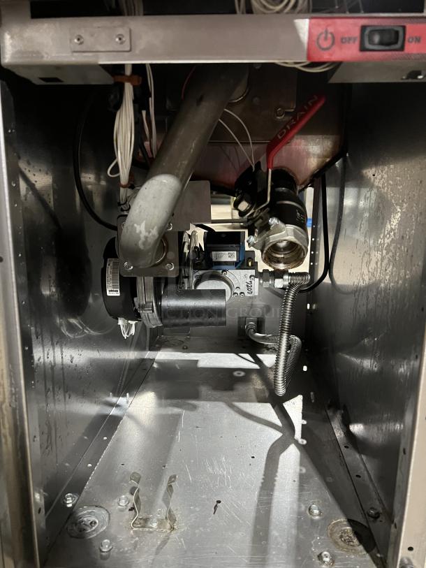 Vulcan PowerFry3 1TR45D1 deep fryer interior view, showing burner and gas connections. Stainless steel, on casters.