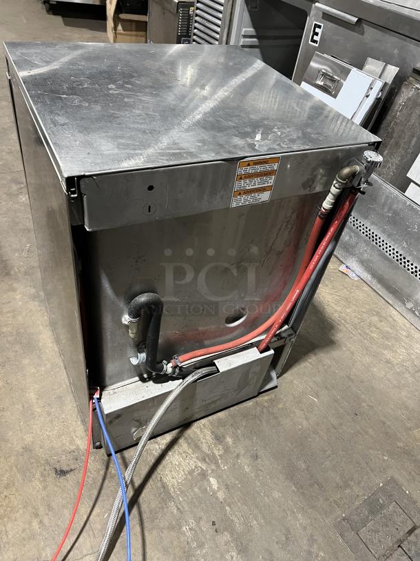 Hobart LXe commercial stainless steel undercounter dishwasher, showing back view with hoses and warning labels.