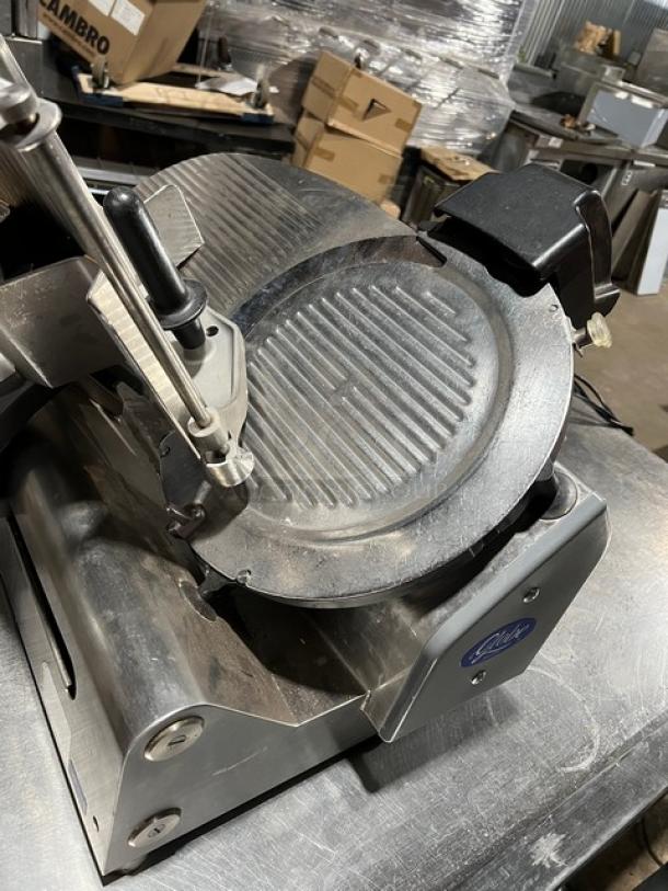 Globe commercial electric countertop meat deli slicer on legs, visible wear, sturdy build, ideal for deli use.