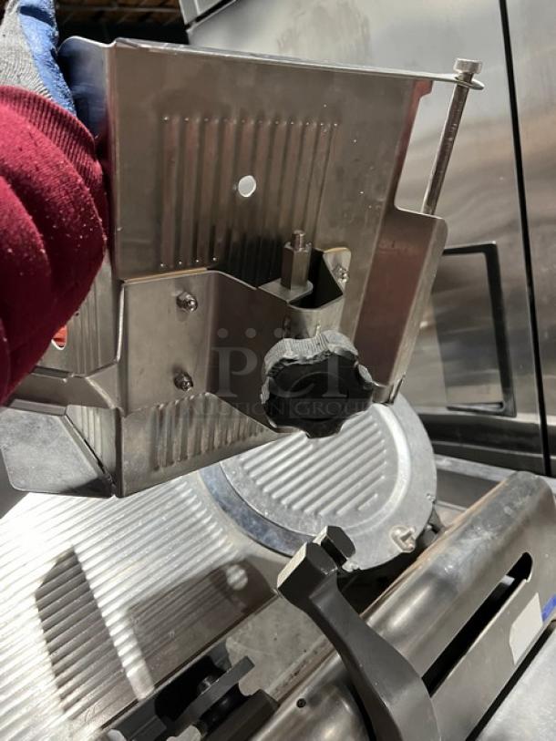 Globe electric countertop meat deli slicer with adjustable blade, stainless steel construction, on sturdy legs, in used condition.