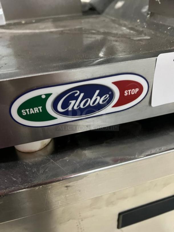 Globe commercial electric countertop meat deli slicer, in good condition, features start/stop controls, stainless finish.