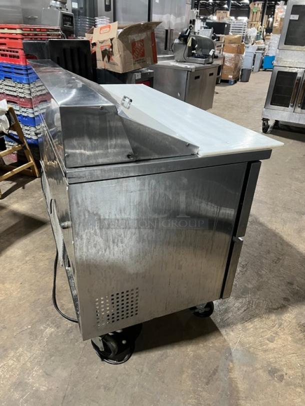 True TSSU-60-16D-4 stainless steel prep table, 4 drawers, 60", cutting board, good condition, on casters, 115V.