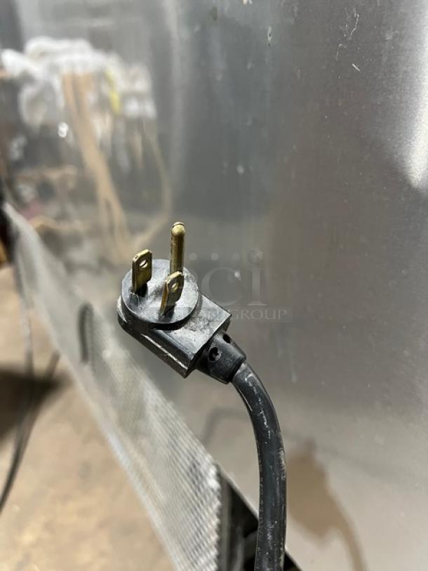 True TSSU-60-16D-4 60" refrigerated prep table, stainless steel, on casters, with cutting board. Model and serial number visible.