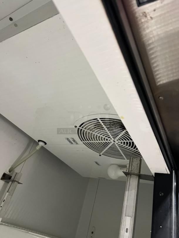 True T-49 commercial refrigerator interior, showing fan and wiring; model T-49, Energy Star certified, poly-coated rack.