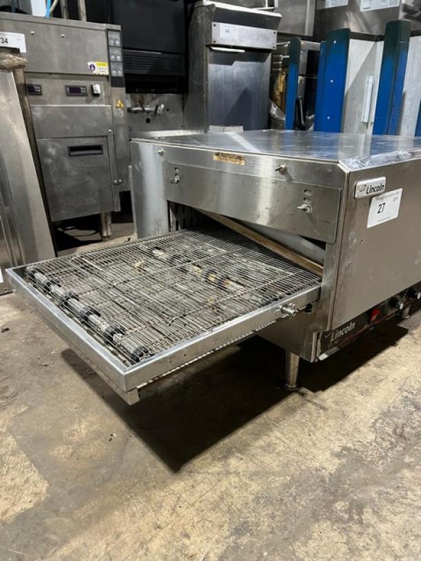 Lincoln 1301 stainless steel electric conveyor oven, used, on legs, 208V, 1 Phase, SN: 1311230000386, with open conveyor.