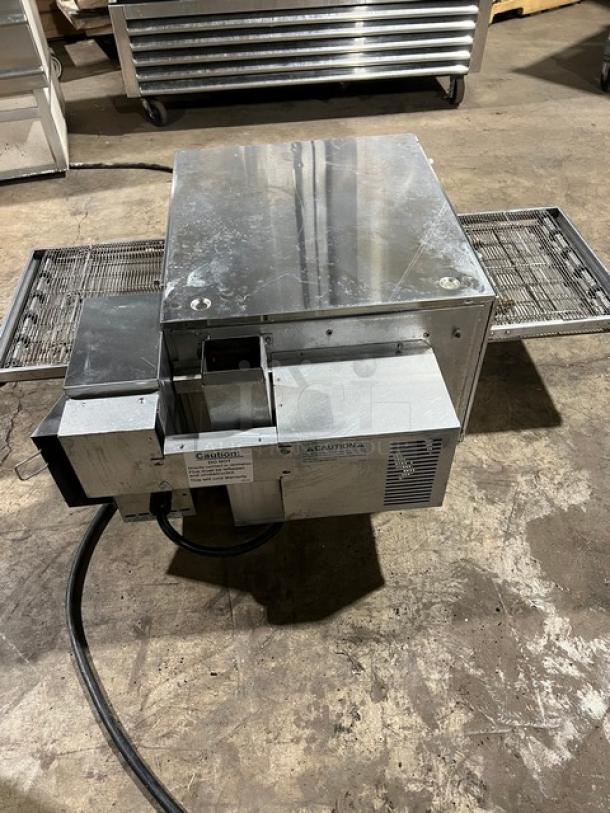 Lincoln Model 1301 stainless steel conveyor oven on legs. Electric powered, 208V 1 phase. Features caution and operation labels.