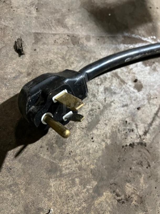 Power plug for a Lincoln Model 1301 conveyor oven, 208V, 1 Phase, shown on a concrete floor.