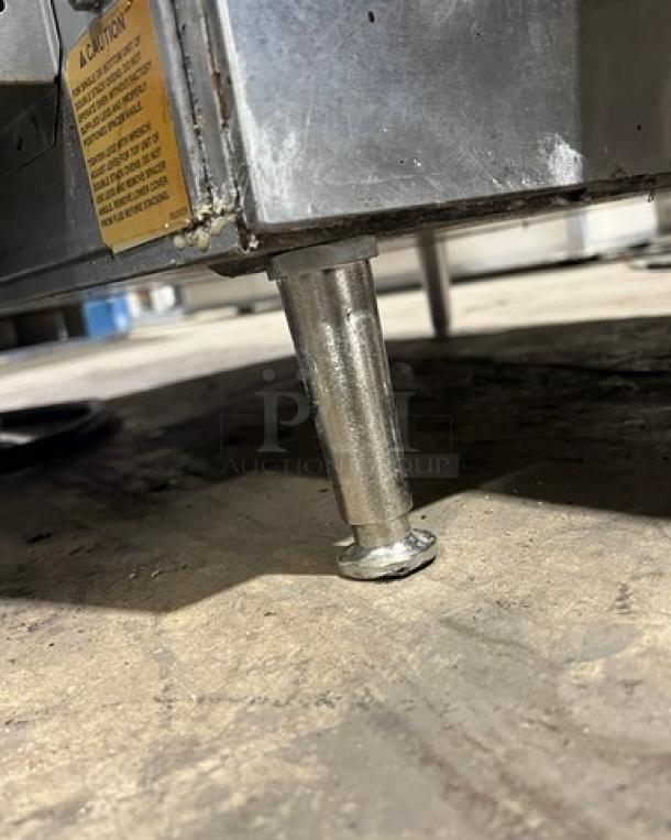 Lincoln Model 1301 stainless steel electric conveyor oven, 208V 1 Phase, elevated on legs, visible caution label, SN: 1311230000386.