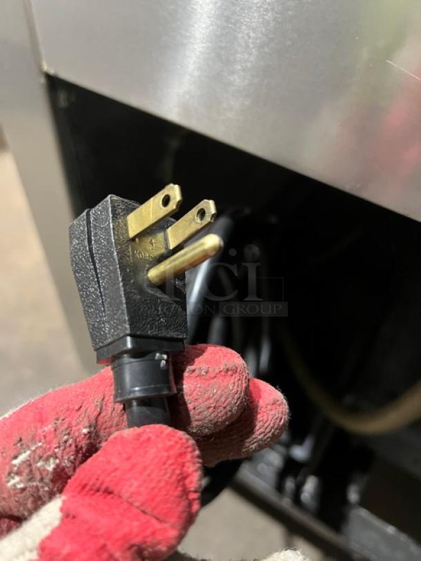 True T-23 single door reach-in refrigerator, stainless steel, with poly-coated wire rack; features durable casters. Model T-23, SN: 1-3522772, 115V 1 Phase plug shown.