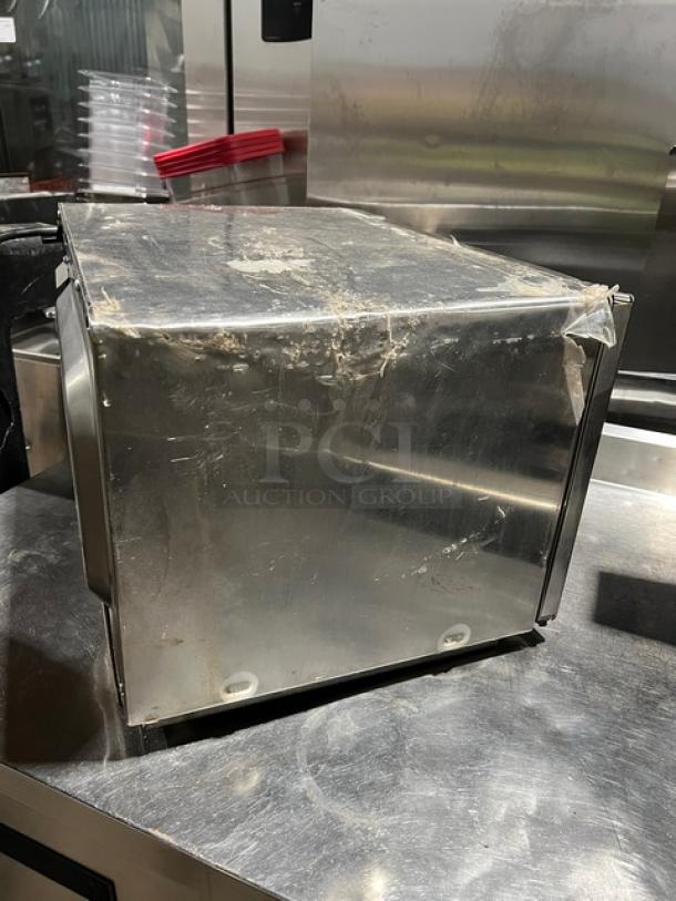 Amana 2021 stainless steel commercial microwave, model RCS10TS. Features digital push control, visibly used condition.