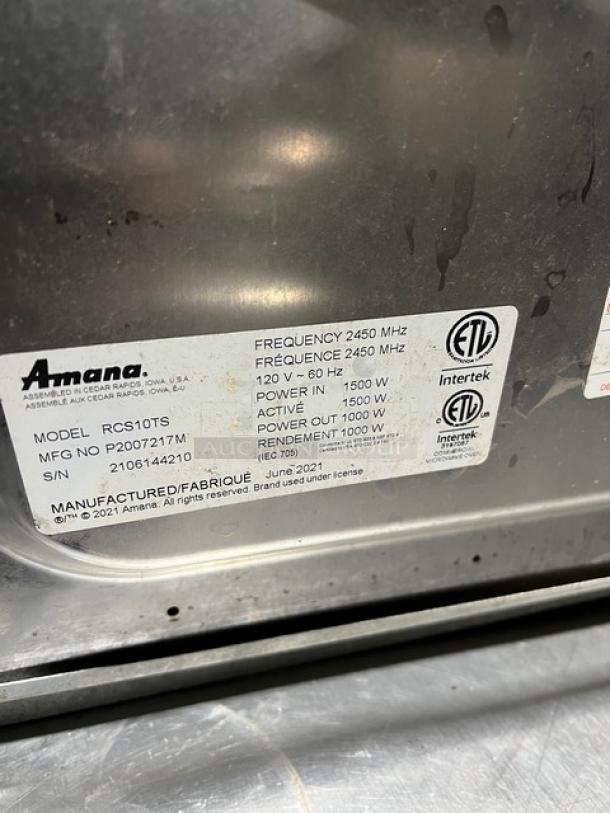 Amana 2021 stainless steel commercial microwave, model RCS10TS, digital controls, 120V. Serial number: 2106144210.