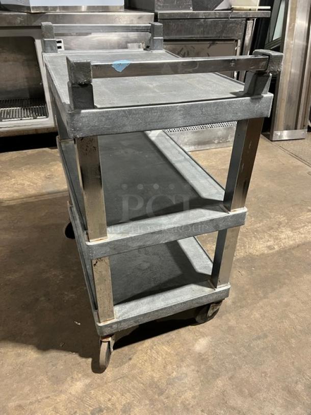 Commercial heavy-duty multi-tier utility/bus cart on casters, gray metal, three shelves, used condition, sturdy for transport.