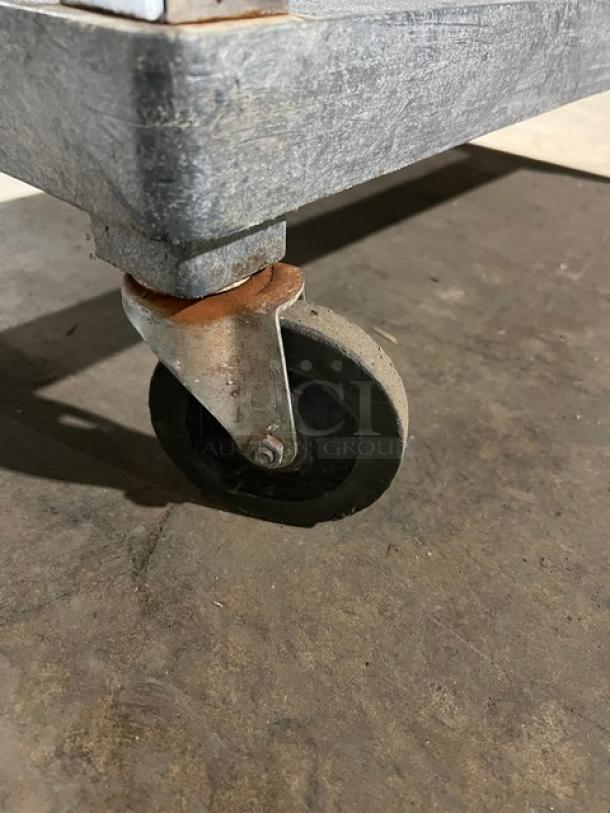 Commercial heavy-duty multi-tier utility cart on casters. Sturdy metal construction, visible wear, great for businesses.