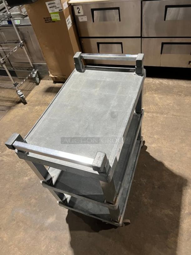 Heavy-duty multi-tier utility bus cart with casters, metal frame, gray shelves, in good condition, ideal for commercial use.