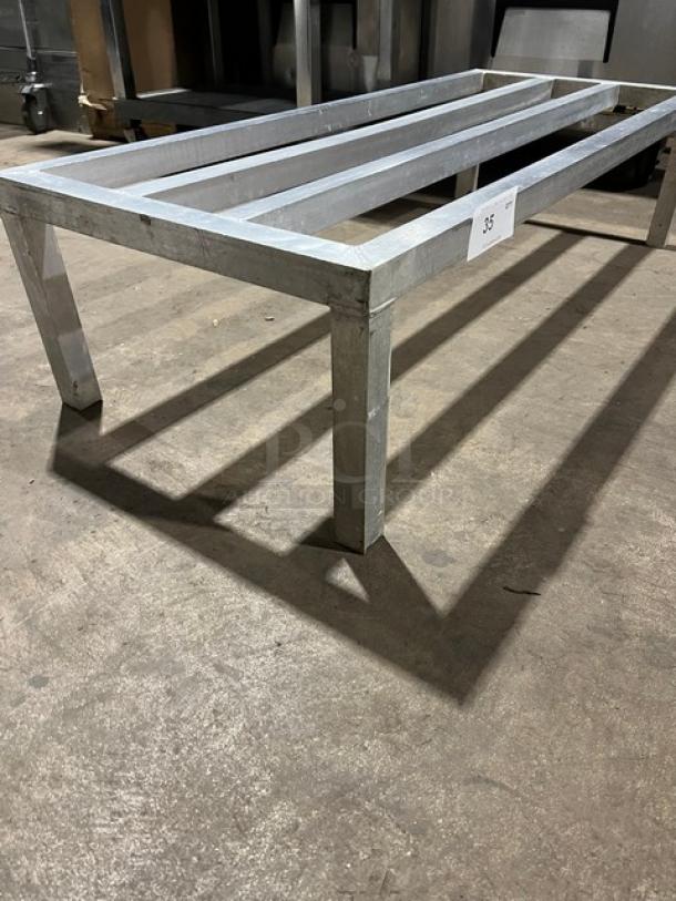 Commercial aluminum heavy-duty dunnage rack on legs, in good condition, made for heavy storage. Visible number tag: 35.