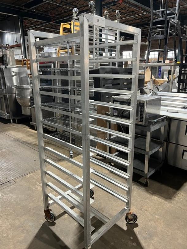 Alexander Industries commercial aluminum 12-pan sheet rack on casters. Heavy-duty, excellent condition, industrial setting.