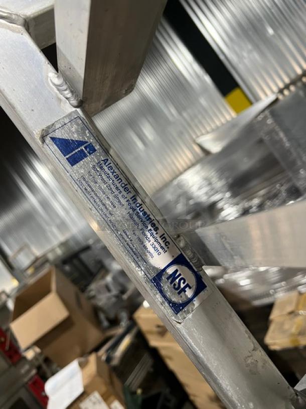 Alexander Industries aluminum 12-pan sheet rack on casters, NSF certified. Features rugged construction for commercial use.